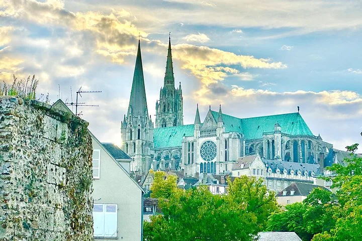 Chartres Cathedral viewed from a distance amidst green trees