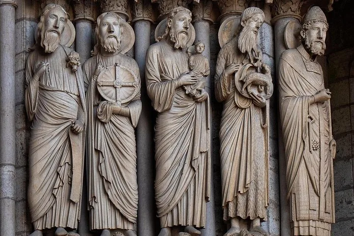 Detailed stone statues of biblical figures on a cathedral facade